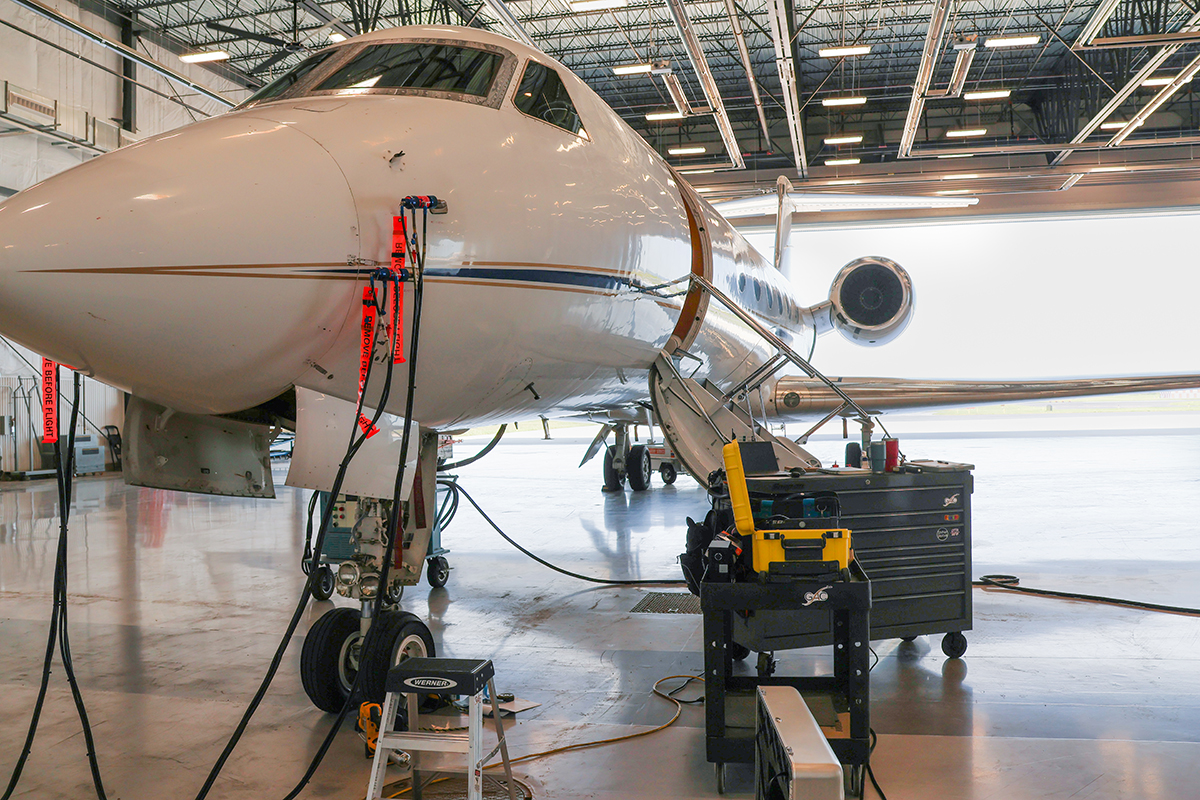 Close up of private jet receiving pre-purchase inspection by Global MX team