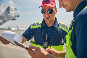 Concentrated aircraft maintenance supervisor looking over aircraft logbook review